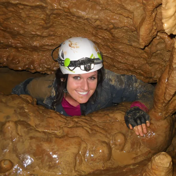 Girl crawling out of cavern