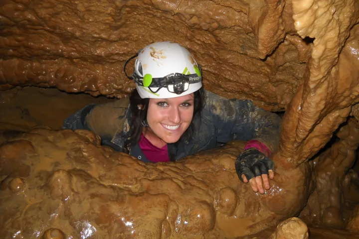 Girl crawling out of cavern