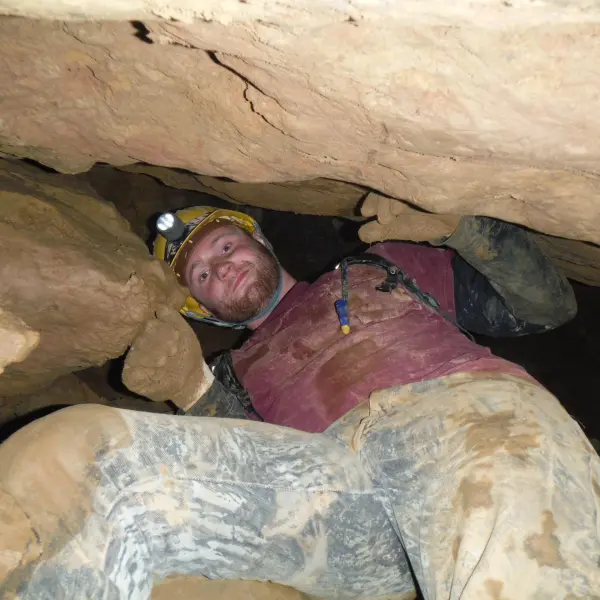 Man climbing down cave